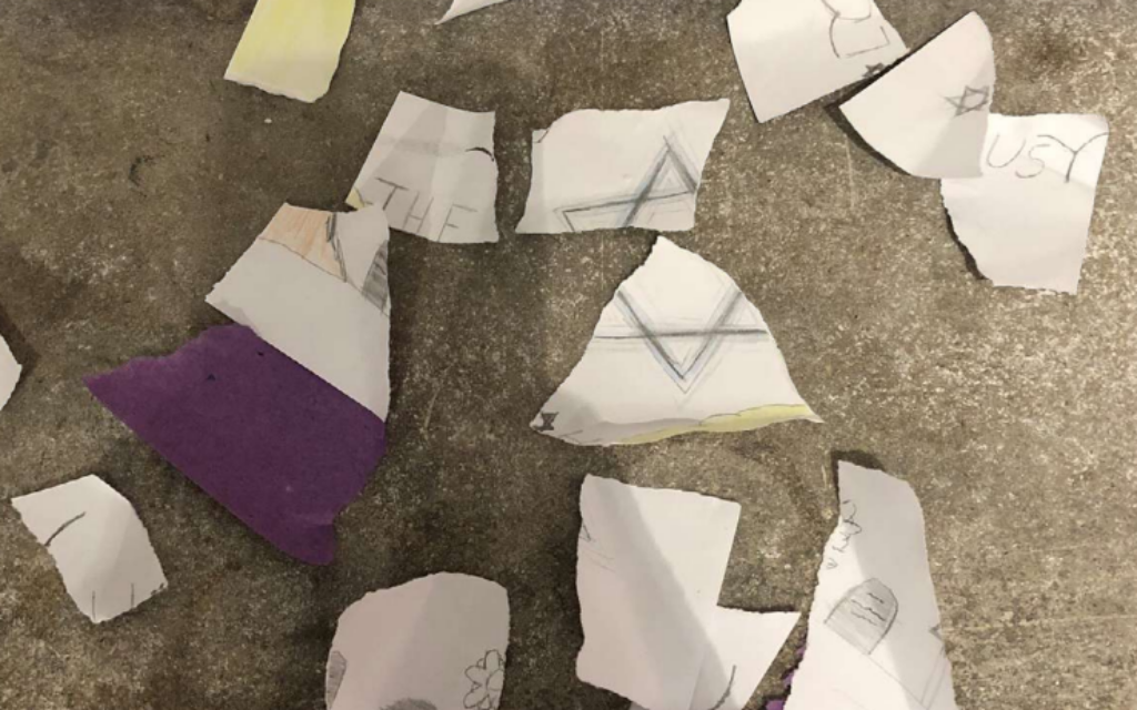 A ripped up artwork from a display at a University, featuring artwork from local school students commemorating Holocaust Memorial Day. The picture in question featured a Star of David