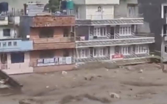 Floodwaters surge through a town in Nepal following days of extreme weather. Photo via X