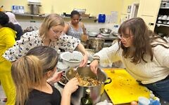 Members of Westminster Synagogue cook alongside refugees and asylum seekers at the launch of A Place at the Table. Photo Credit: Omer Cura