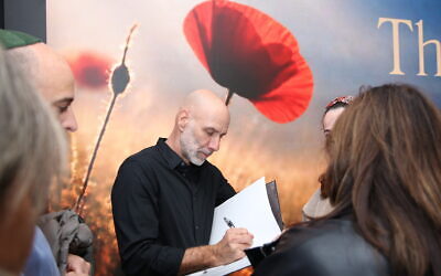 Photographer Ziv Koren signs books credit Galia Verthime Sherf.
