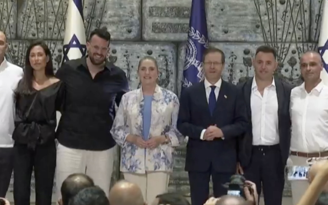 President Isaac Herzog with six Israelis honoured for helping foil the attempted hijacking of a flydubai flight to Tel Aviv. (Credit: Royan News English)