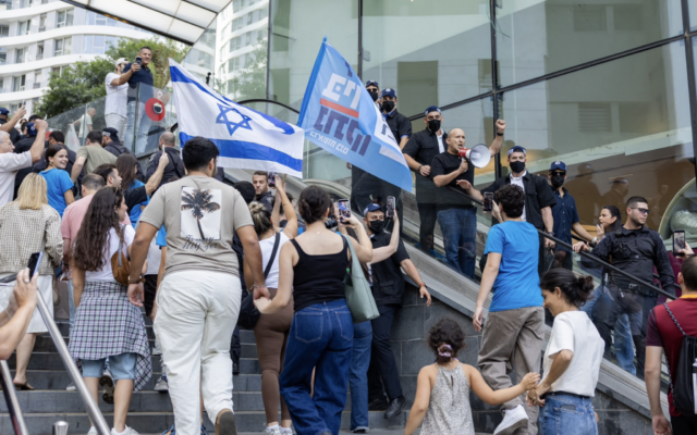 Supporters wave Israeli flags at a political rally in Israel. Photo Credit: Itay Shaked