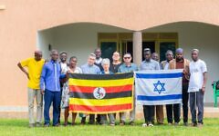 The Israeli and Ugandan flag held up in symbol of solidarity outside synagogue. Pic: WJR The Israeli and Ugandan flag held up in symbol of solidarity outside synagogue. Pic: WJR