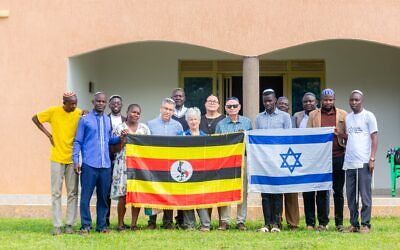 The Israeli and Ugandan flag held up in symbol of solidarity outside synagogue. Pic: WJR
