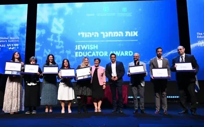 The eight recipients of the inaugural Global Jewish Teacher Award at the Global Jewish Educator Conference in Jerusalem, Oct. 12, 2026. From right: Rabbi Zvi Lew, United States; Tal Kattan, South Africa; Meir Bunytow, Mexico; Anat Kampf, United States; Raquel Hakim, Argentina; Dina Jacobson, Britain; Marina Grushevskaya, Russia; and Rahel Israeloevitch, France. Photo by Yuval Yosef/GPO.